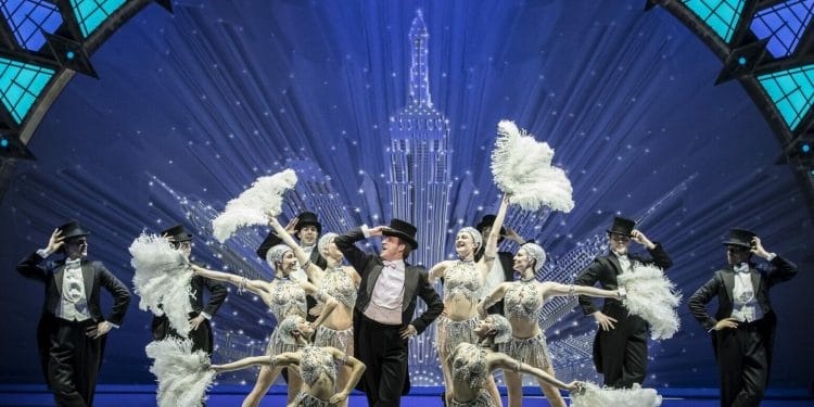 Haydn Oakley, centre, with the cast of An American in Paris at the Dominion Theatre CREDIT Johan Persson