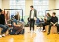 Ryan Kopel centre standing and the cast in rehearsals for The Astonishing Times of Timothy Cratchit credit Pamela Raith