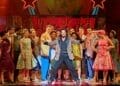 Peter Andre as Vince Fontaine centre with the company in GREASE credit Manuel Harlan