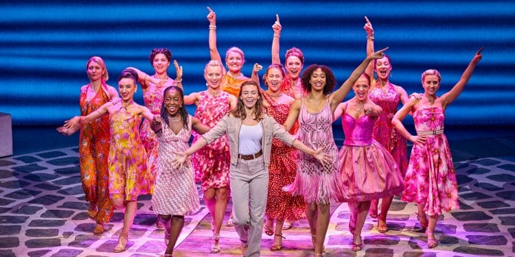 Stevie Doc as Sophie (front centre) with the cast of MAMMA MIA!, credit Brinkhoff-Moegenburg